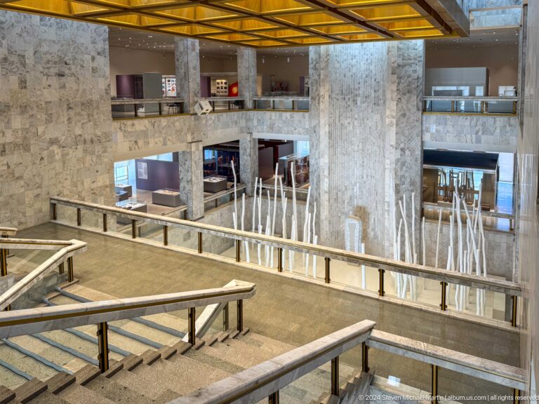 Wide view of monumental museum atrium and railings.