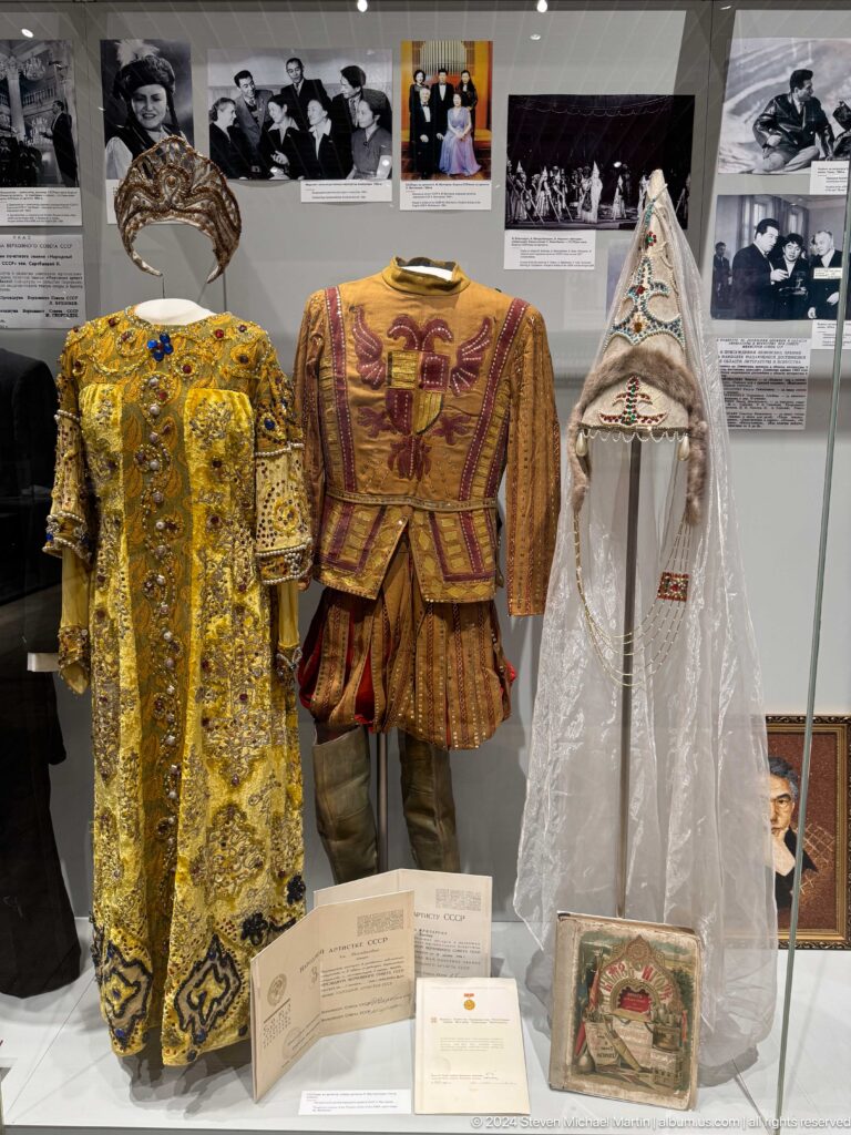 Three ornate traditional garments on mannequins.