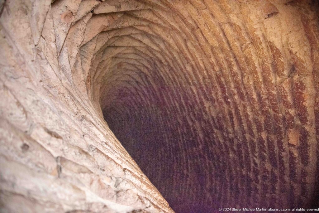 A narrow brick-vaulted passage curves upward inside the minaret