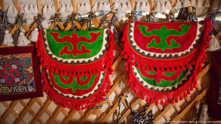 Two matching felt panels display vivid red, green, and white curvilinear ornament