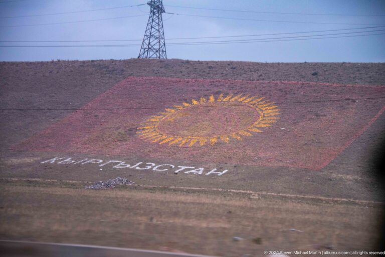 Kyrgyz flag design laid across a hillside.