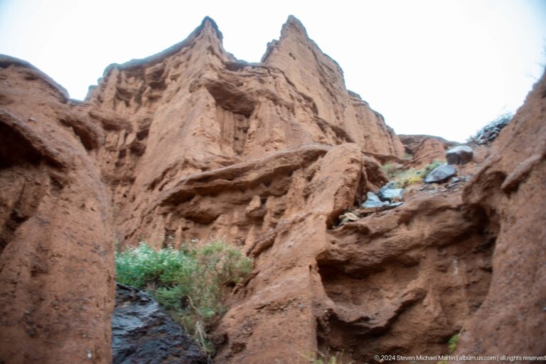 Steep sculpted canyon walls with visitor partly visible.