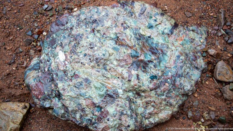 Close-up of multicolored mineral-stained rock surface.