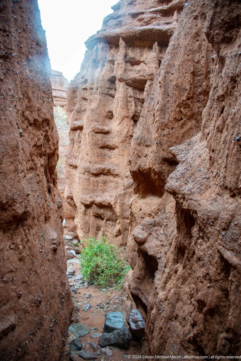 Visitor emerging through a very narrow canyon gap.