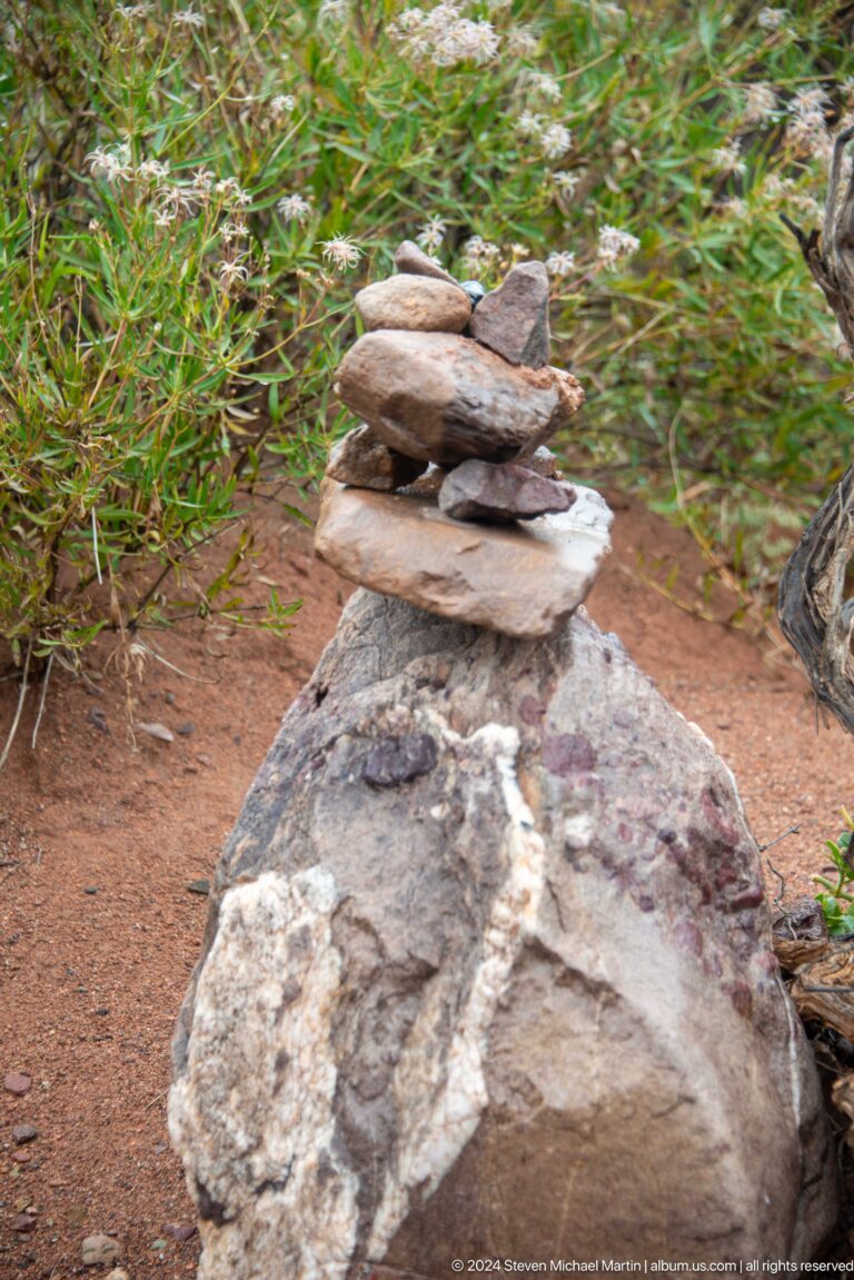 Small stack of flat stones balanced on larger rock.