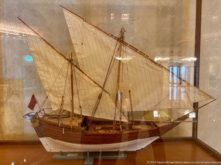 Model of traditional sailing vessel in display case in Muscat, Oman.