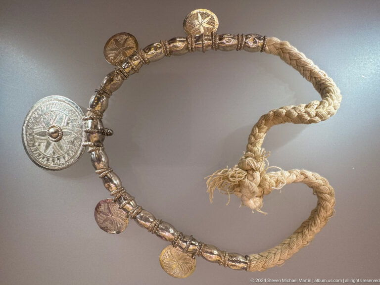 Heavy silver necklace with animal-shaped central ornament in Muscat, Oman.