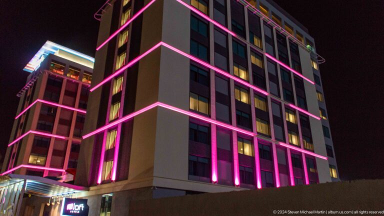 Modern facade outlined in magenta light in Muscat, Oman.