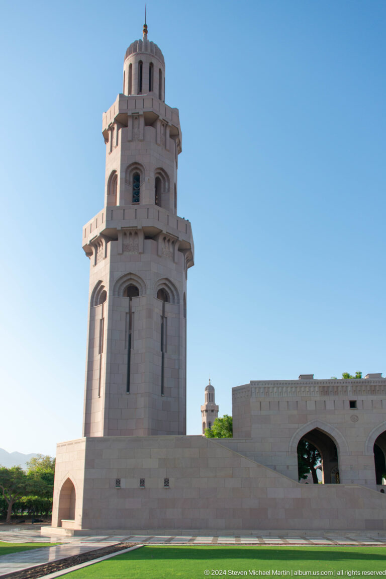 White minaret shaft against blue sky in Muscat, Oman.
