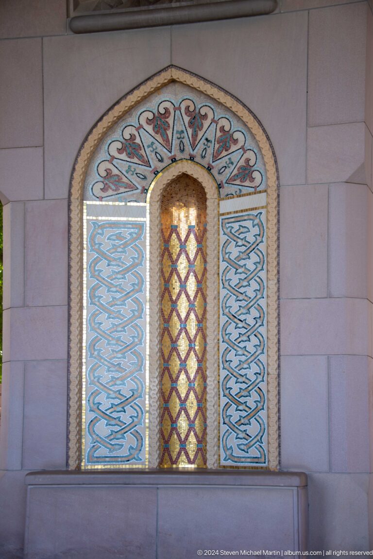 Narrow stained-glass window in blue patterned surround in Muscat, Oman.