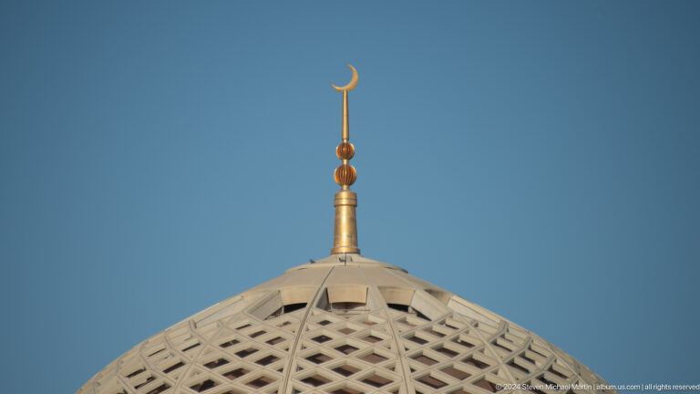 Gold finial atop geometric dome in Muscat, Oman.