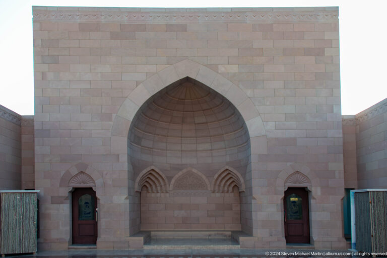 Large recessed pointed arch with carved niche in Muscat, Oman.