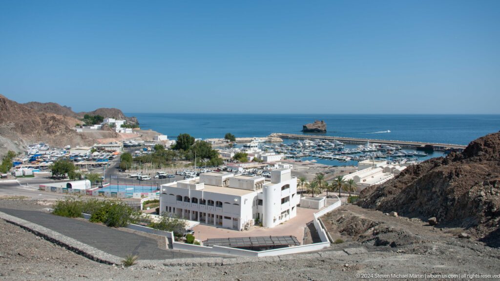 Coastal district and harbor viewed from above in Muscat, Oman.