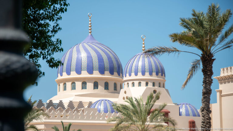 Blue-and-white striped domes among palm trees in Muscat, Oman.