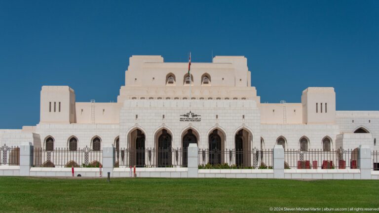 Frontal view of white palace-like facade in Muscat, Oman.
