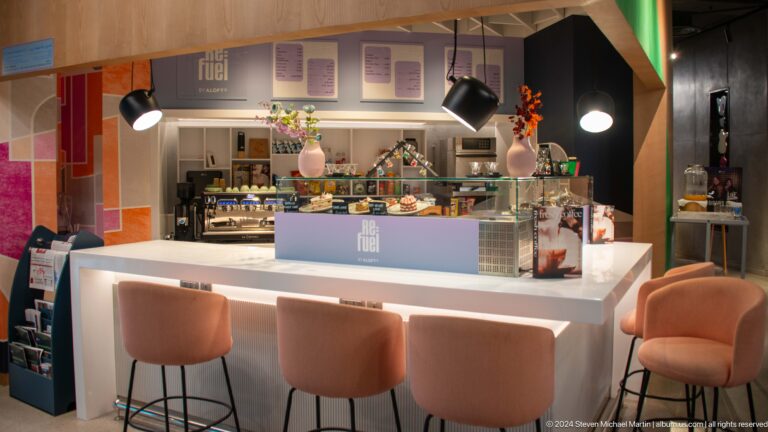 Bright contemporary cafe counter with pendant lights in Muscat, Oman.