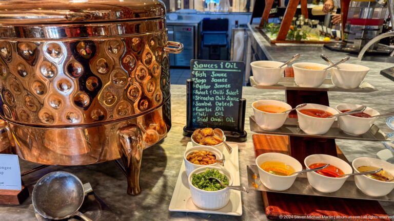 Copper beverage urn with bowls of condiments in Muscat, Oman.