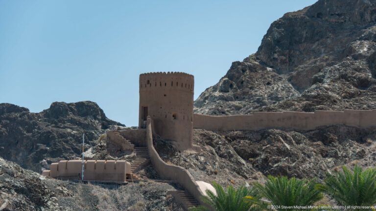 Round watchtower connected to defensive wall.