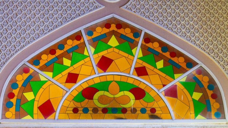 Bright multicolored stained-glass style arch decoration.