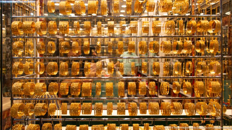 Wall of amber and gold-toned bottles or vessels.