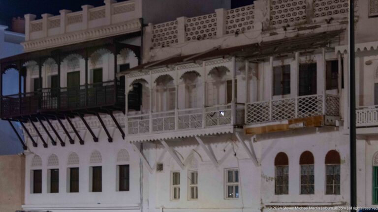Traditional white omani building with projecting balconies.