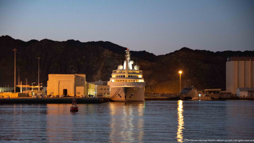 Ferry or passenger vessel moored in harbor at dusk.