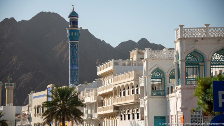 White waterfront buildings and mosque minaret.