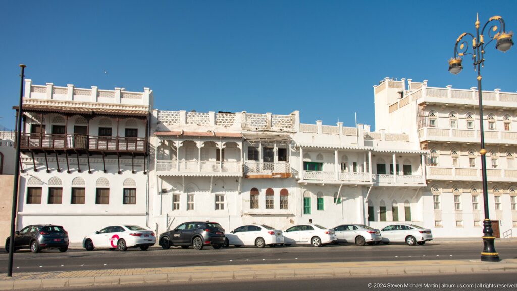 Row of white traditional houses with balconies.