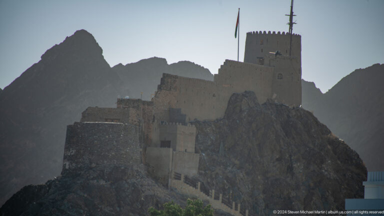 Close view of hilltop fort walls and tower.