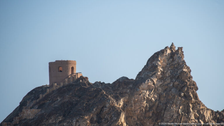 Small square watchtower on jagged ridge.