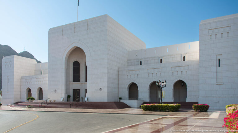 Modern white cultural building with monumental entrance.