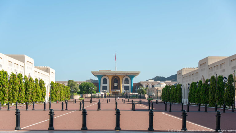 Formal plaza leading toward colonnaded pavilion.