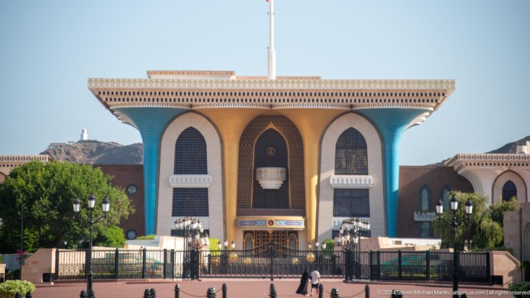 Ornate palace-like façade with three tall arches.