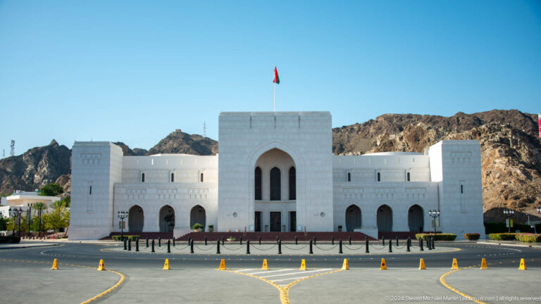 White low-rise civic complex with central tower.
