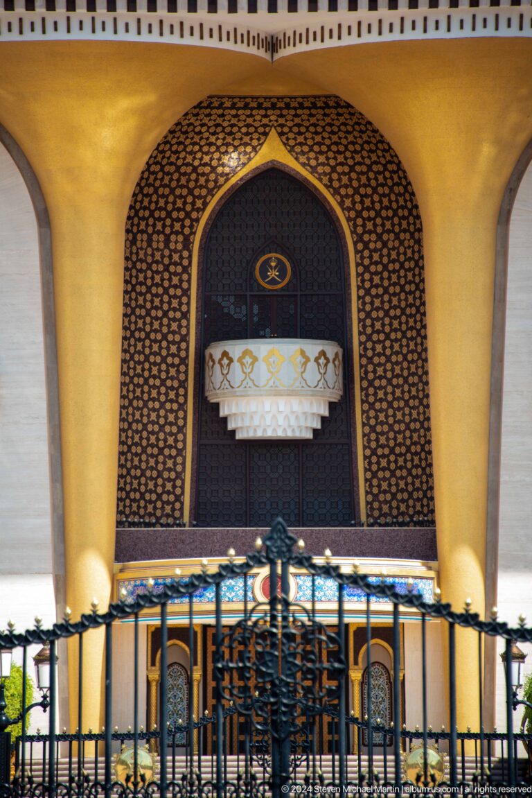 Decorative doorway with chandelier and patterned panels.
