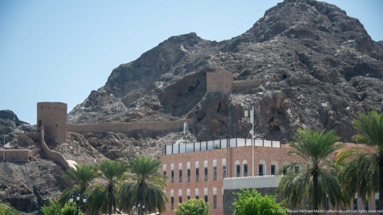 Fortification walls and tower climbing rocky slope.