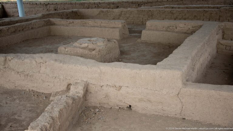 Overhead view of an excavated building plan at Ancient Sarazm, showing rectangular rooms defined by low walls and interior raised platforms.