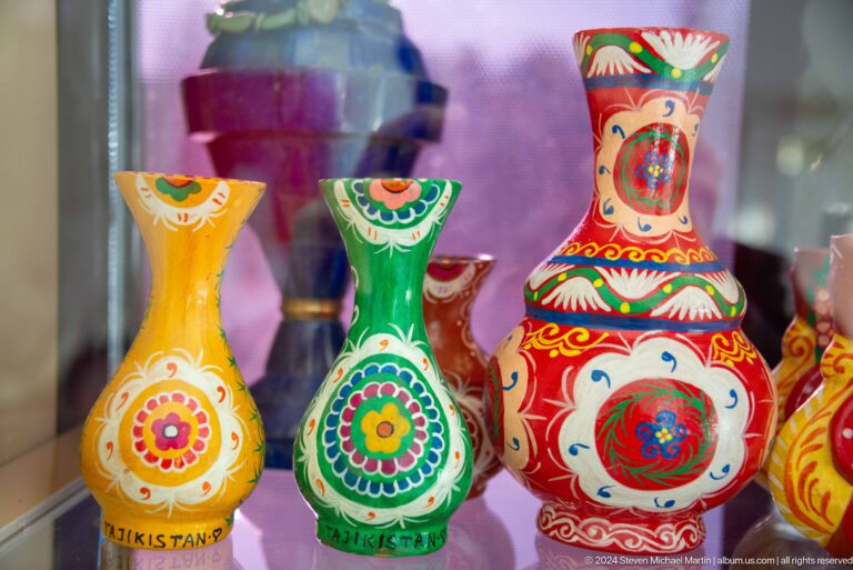 Display of brightly painted ceramic pitchers.