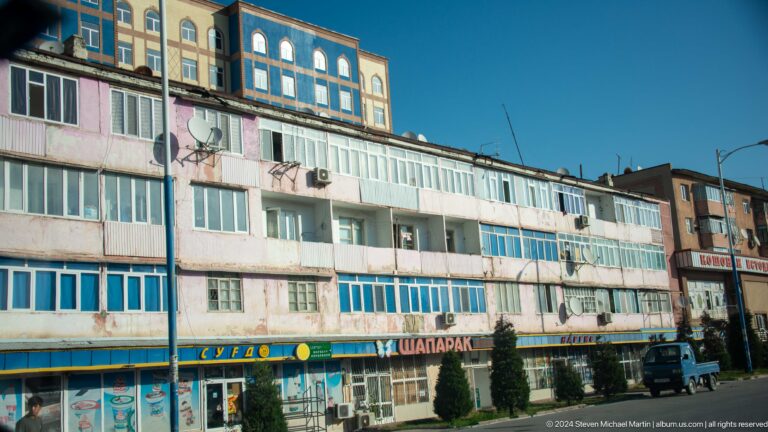 Long commercial block with ground-floor shops.