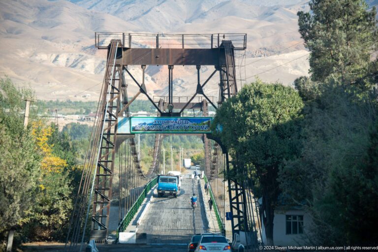 Steel suspension bridge viewed from its approach.