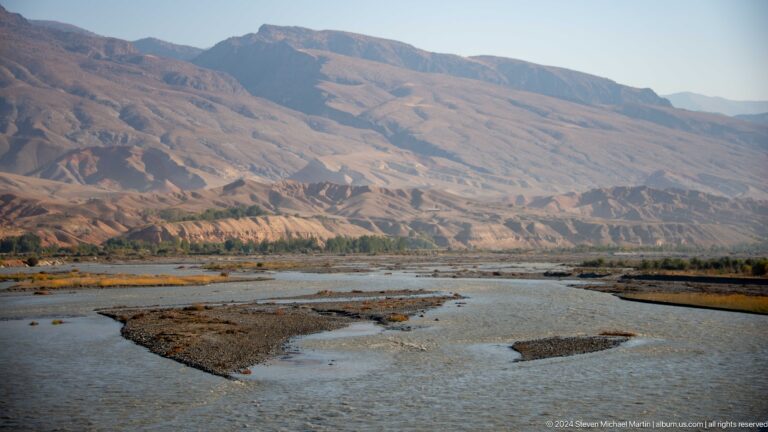 Braided river beneath barren mountain slopes.