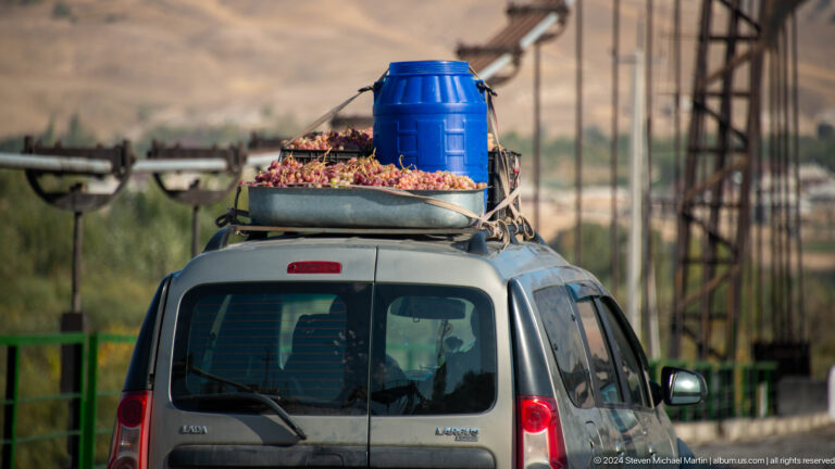 Small van carrying a large roof load.