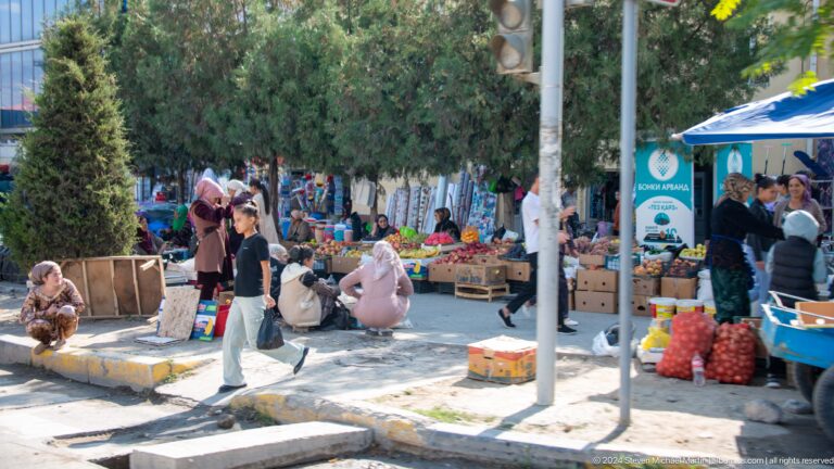 Shoppers and vendors in an open-air market.