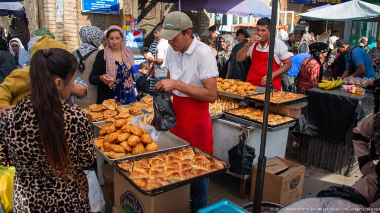 Street-food vendor serving fried pastries.