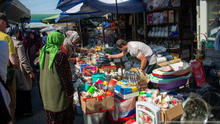Household-goods stall packed with colorful merchandise.