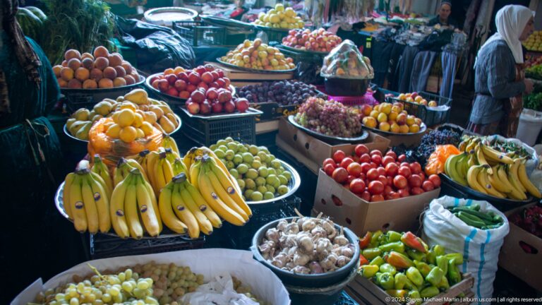 Abundant fruit and vegetable display at a market stall.