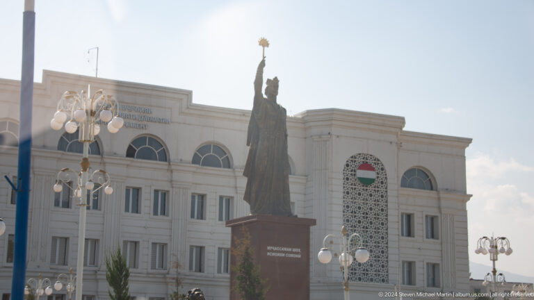 Monumental statue before a civic building.