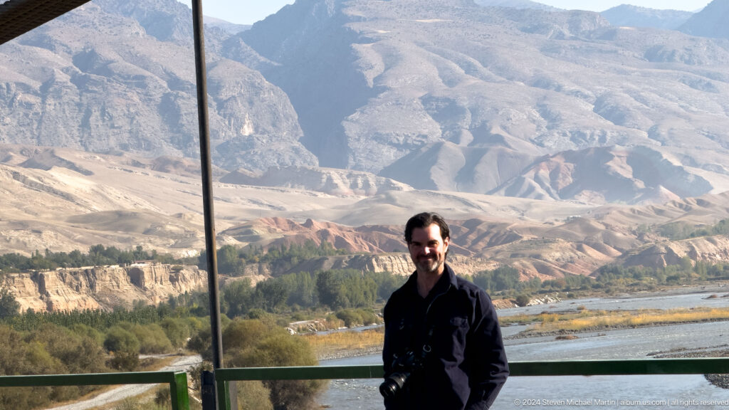 Male traveler standing before the Panjakent mountain valley.