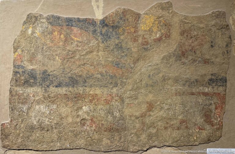 Rectangular plaster fragment with a faint reddish horizontal band of small forms.