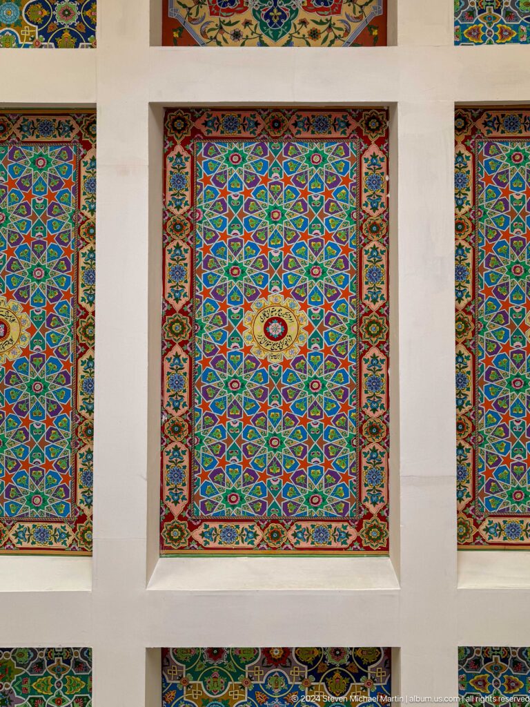 Tall multicolored wall panels filled with star patterns, floral motifs, and decorative borders.